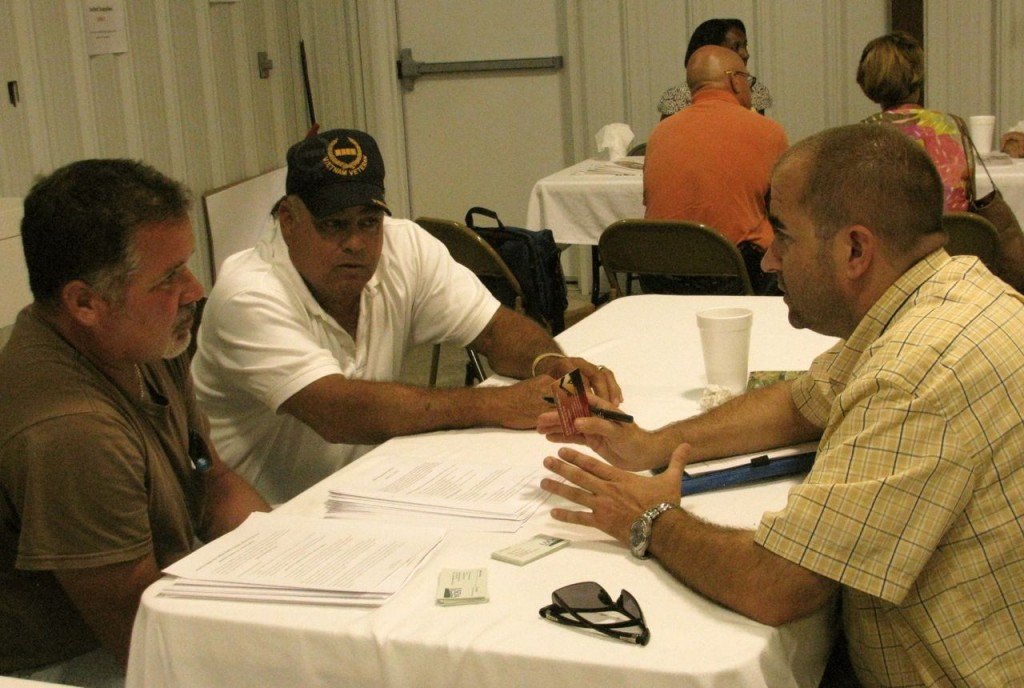 NRCS officer Don Barker explains programs to Gene Jacobs, Chief of the Coharie Tribe, and another member of the American Prawn Cooperative.