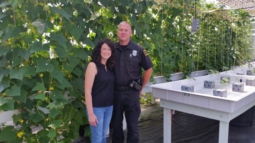 Wendy and Jeff Woolard in front of their climbing cucumbers. (Yes, Jeff is also an NC Highway Patrolman.) 