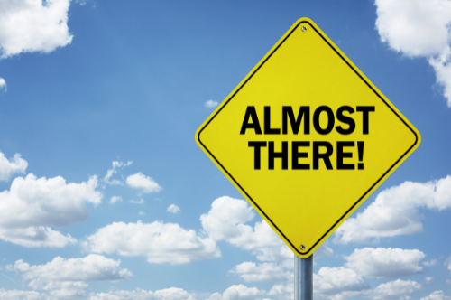 street sign says almost there