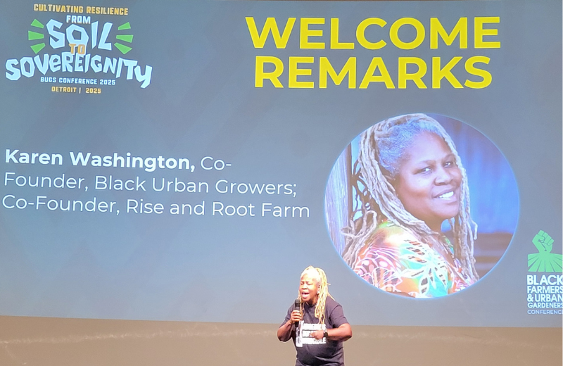 Co-founder Karen Washington giving a high energy welcome address on stage.